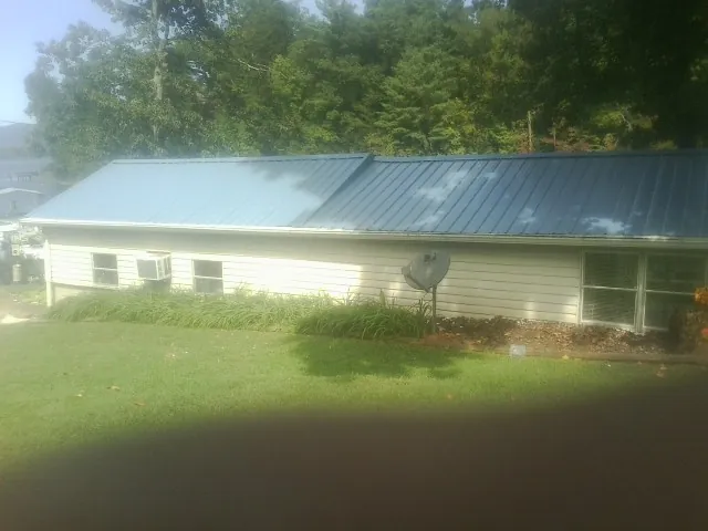 Blue metal roof running the length of a single story home in Goldsmith